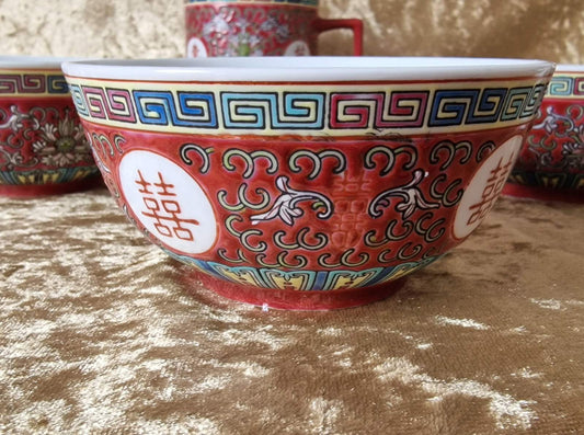 Set of four Chinese Mun Shou porcelain rice/soup bowls featuring red oriental patterns.