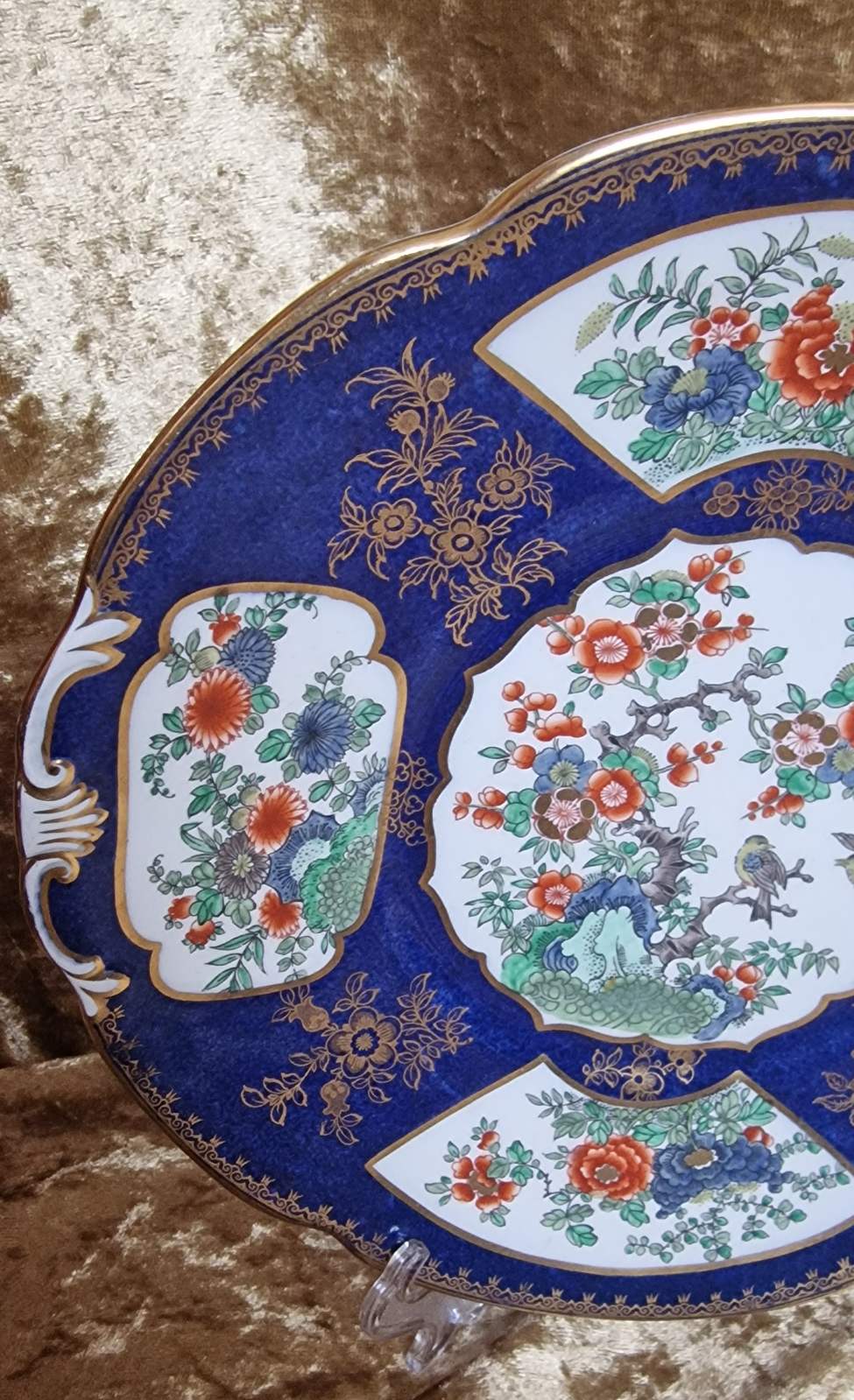 Antique Booths Tiffany plate adorned with blue and gold floral and bird motifs