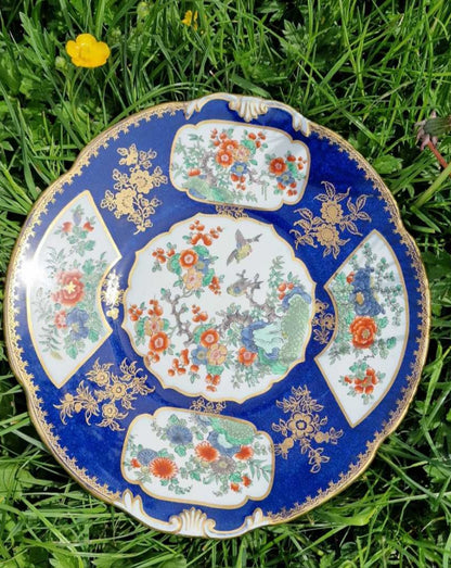 Antique Booths Tiffany plate adorned with blue and gold floral and bird motifs