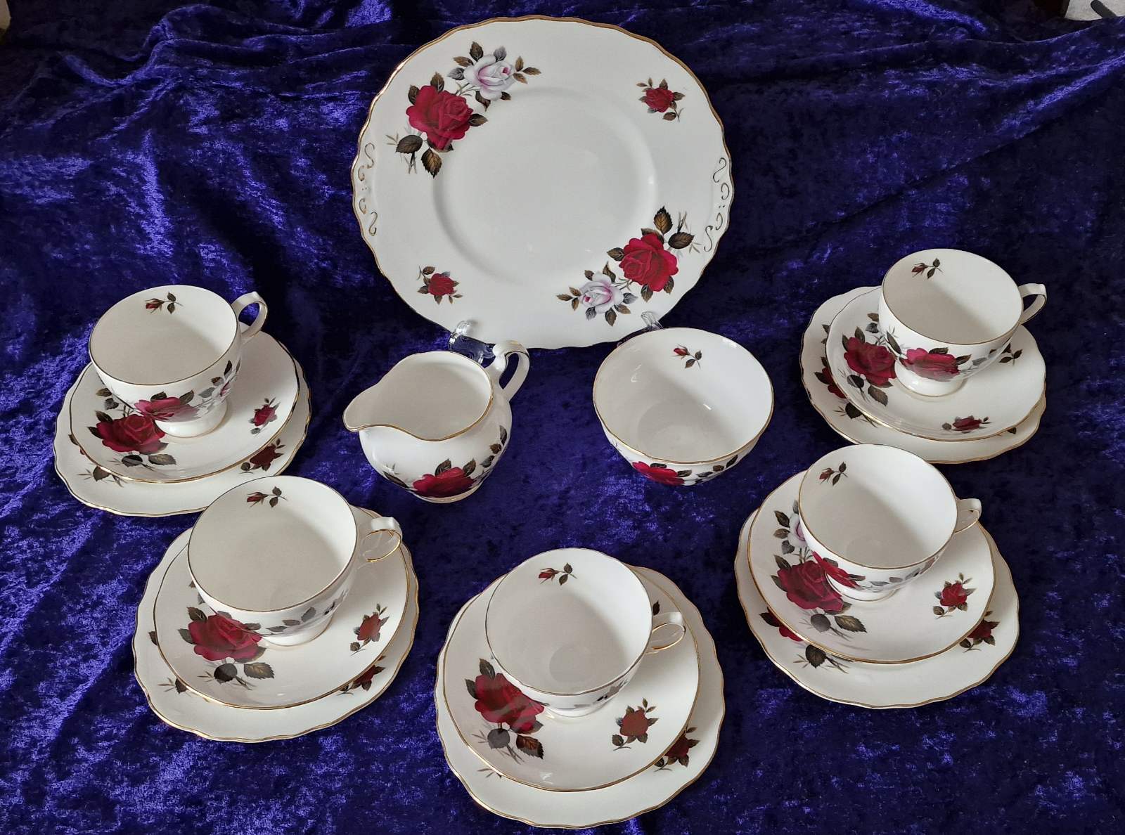 Elegant Colclough "Amoretta Rose" 18-piece tea set with china cups and saucers decorated with roses.