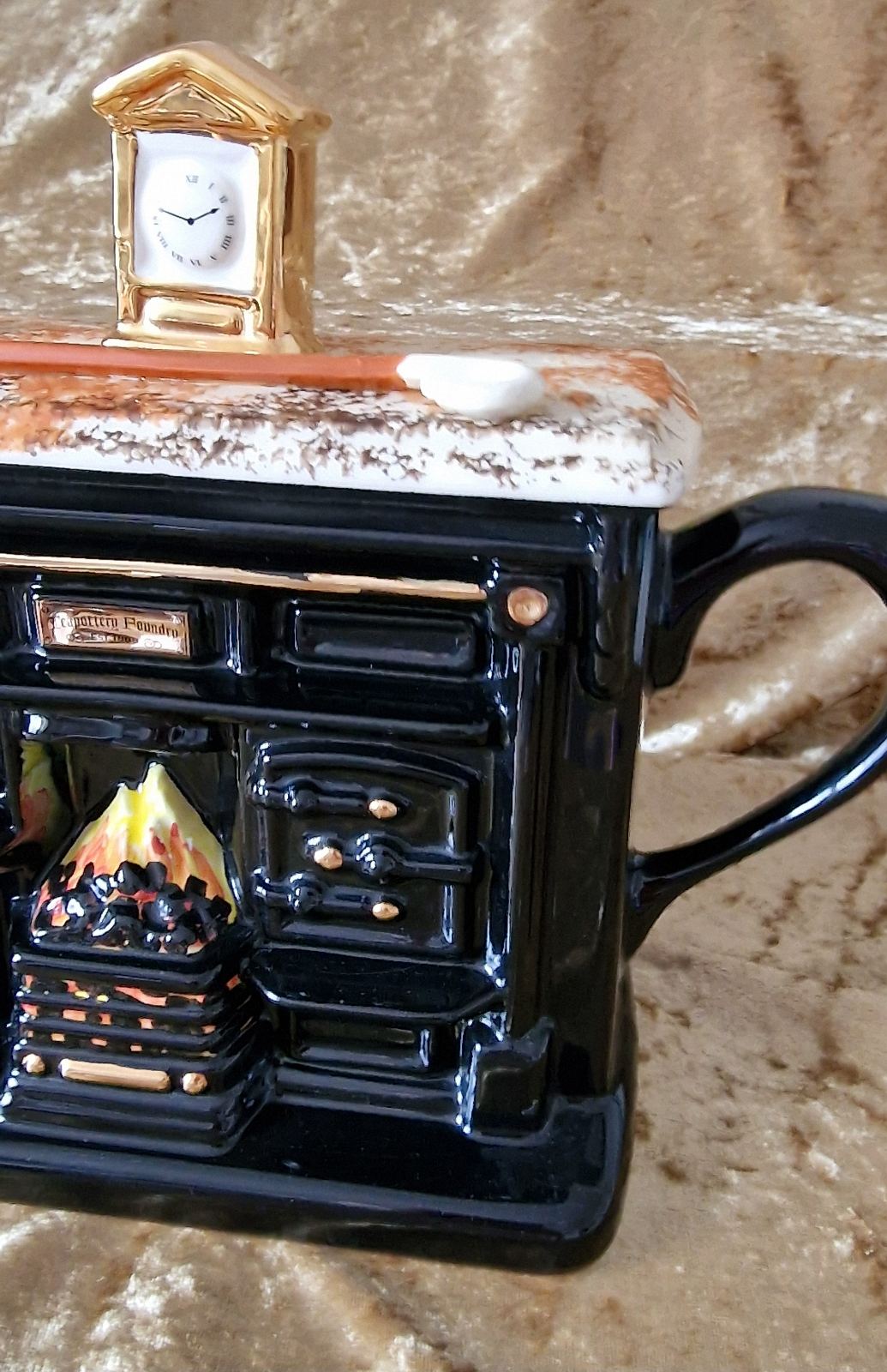 Unique black teapot with fireplace and clock, a prized collectible from Teapottery Company in Yorkshire.